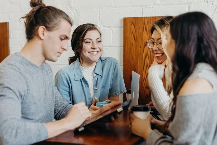 Adult students laughing together around a table